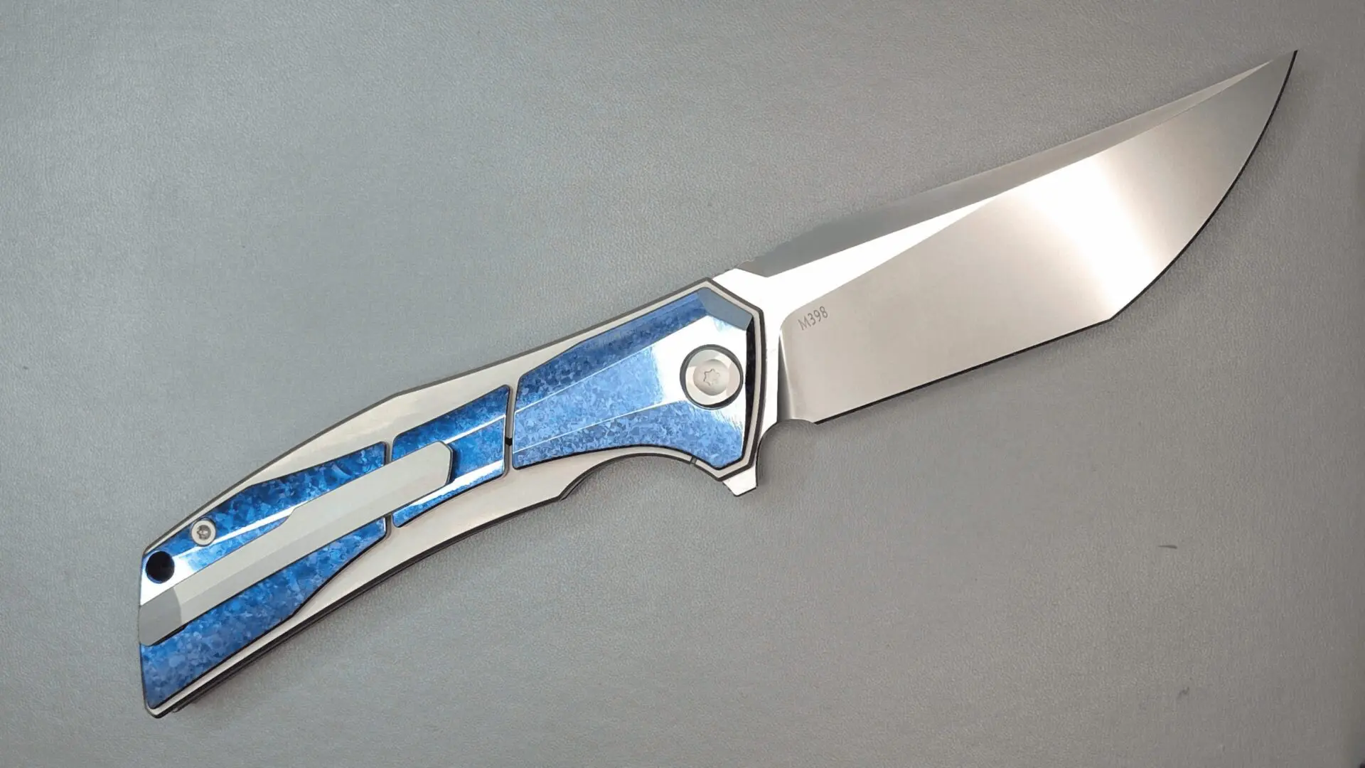 A sleek folding knife with a blue and silver handle.