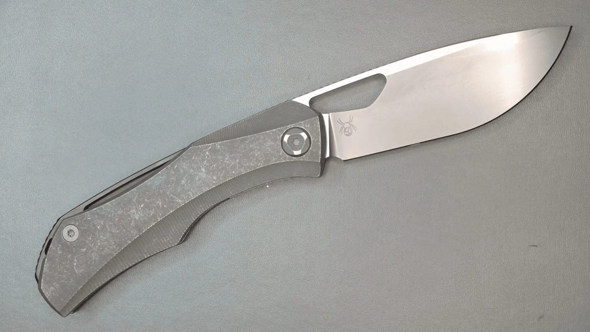 A sleek folding knife with a metallic handle and sharp blade.