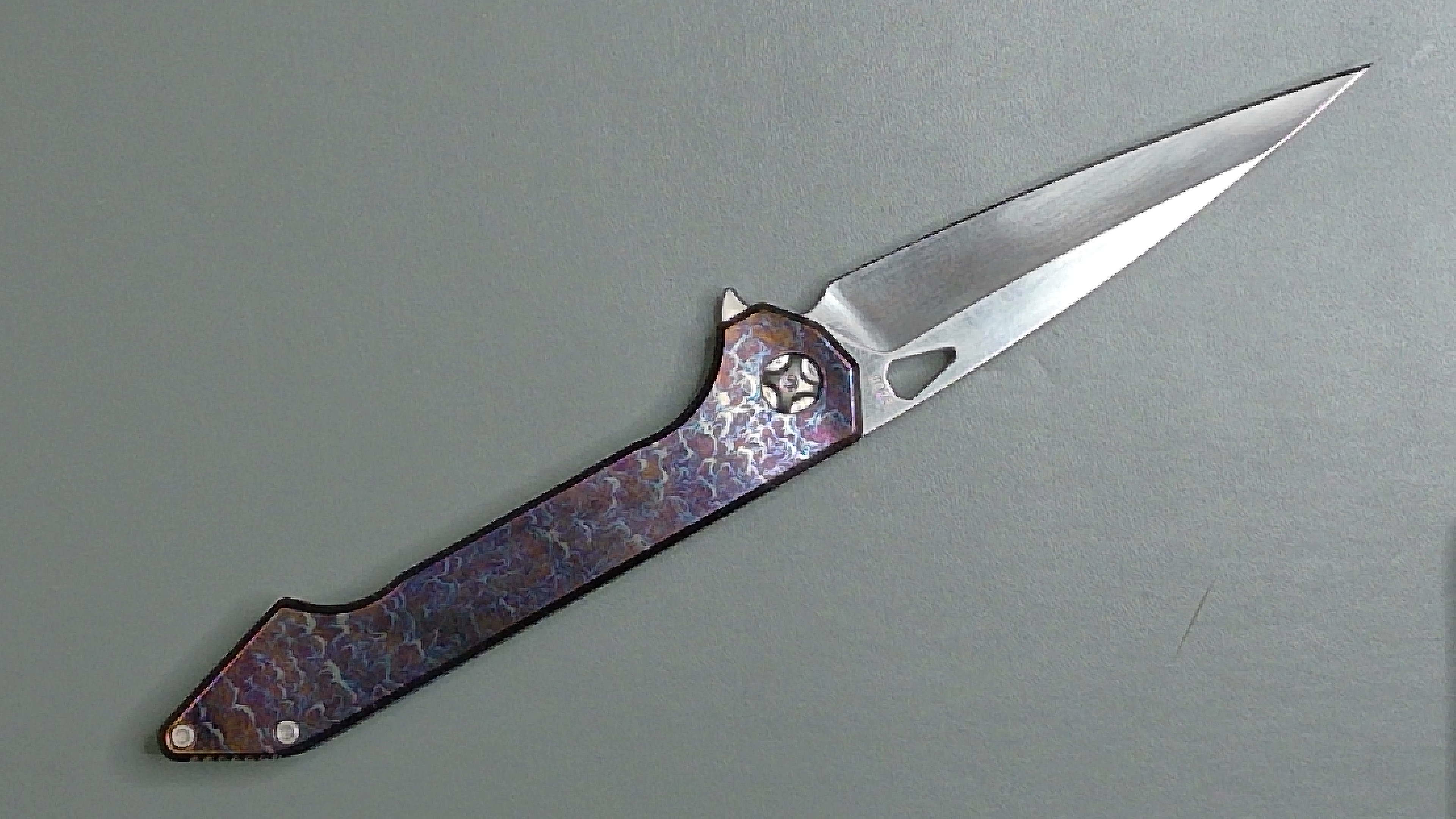 A folding pocket knife with a partially opened blade and metal handle.