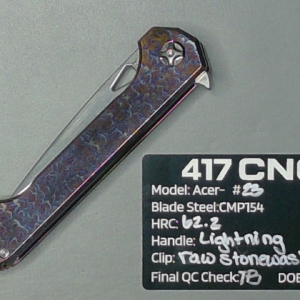 A dark steel CNC-machined blade with detailed specifications.