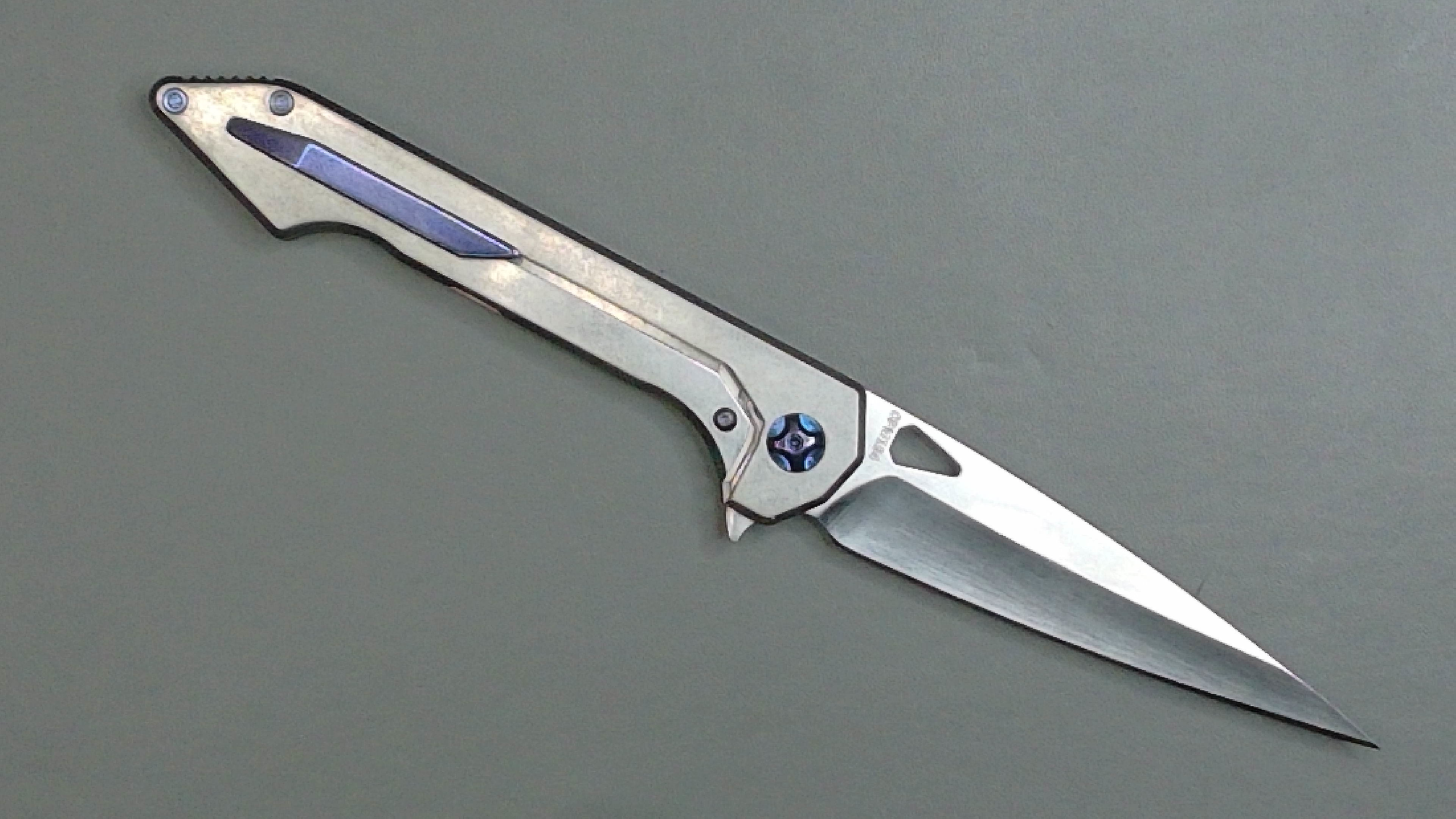 A sleek folding knife with a metallic handle and sharp blade.