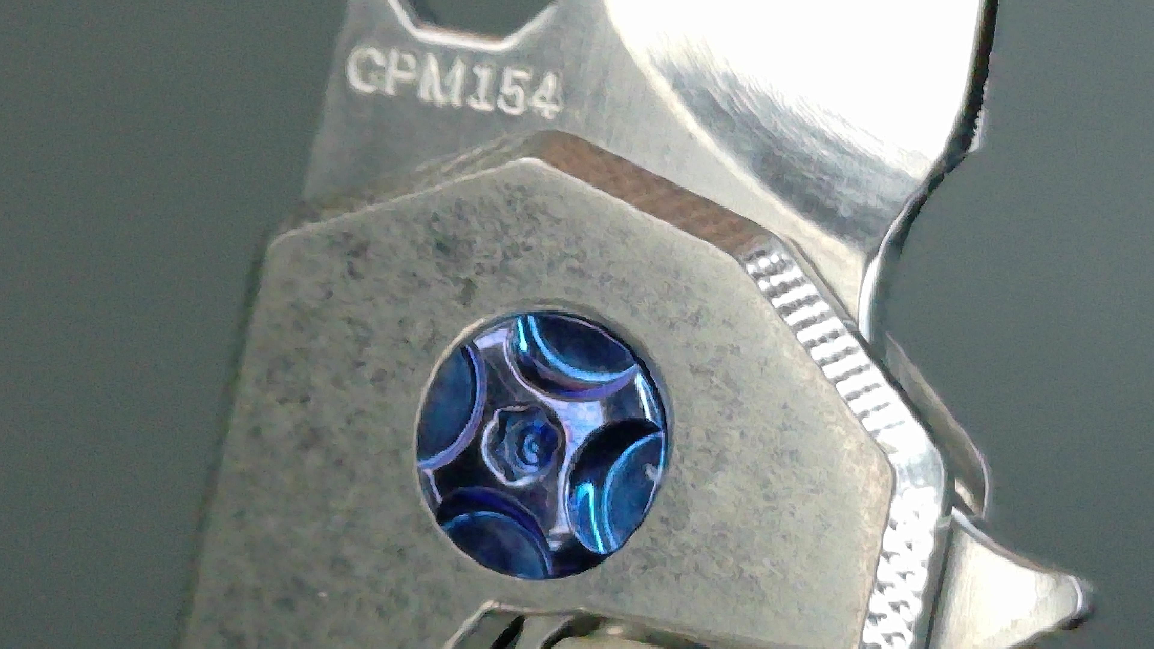 Close-up of a metallic mechanical part with blue circular detail.