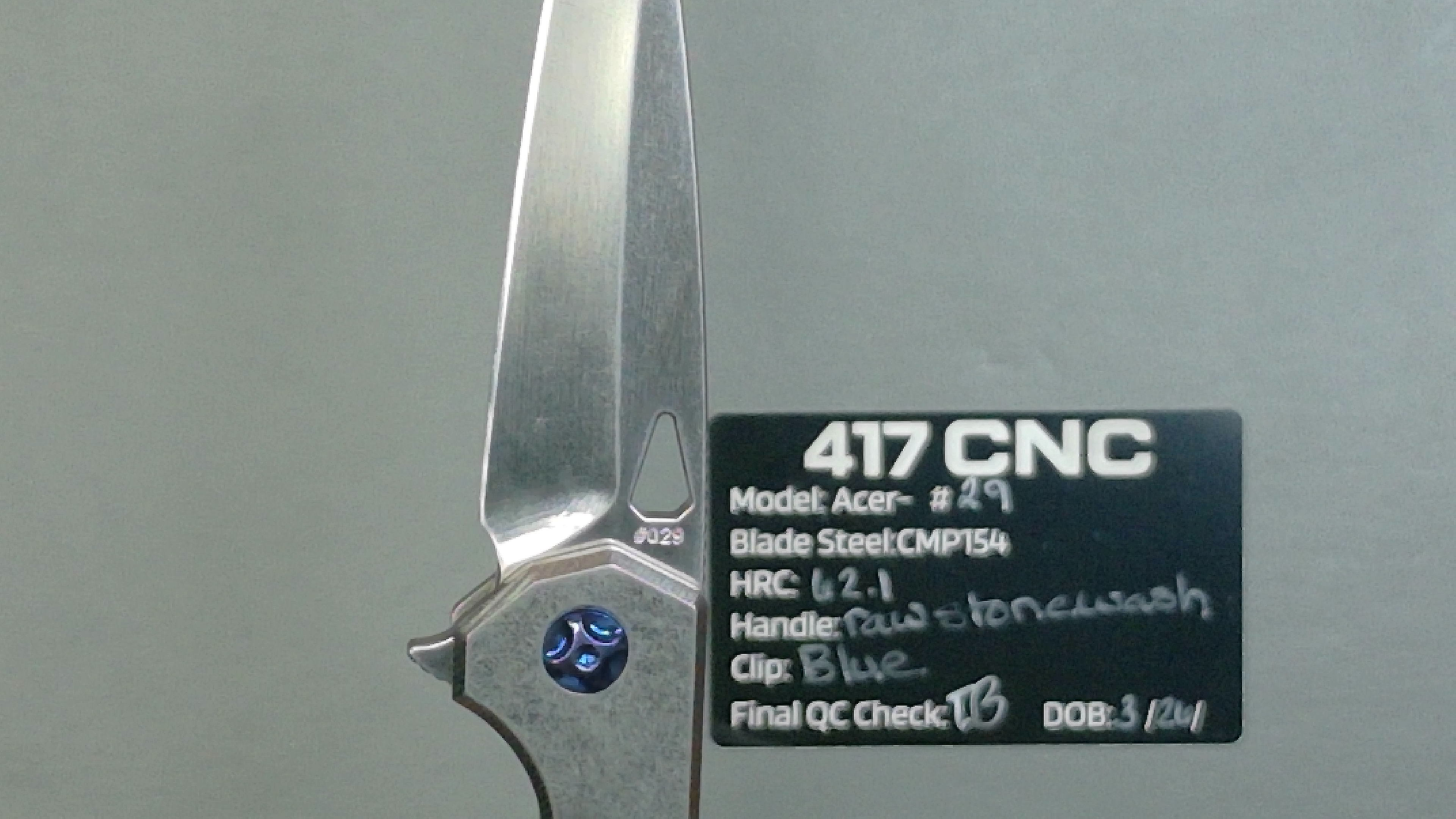 Close-up of a 417 CNC folding knife with detailed blade specifications.
