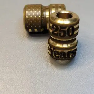 Two small metallic beads with inscriptions, including '250 Years'.