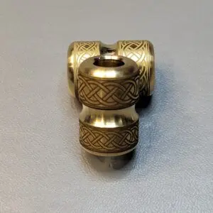 Intricately carved wooden double barrel bead with geometric patterns.