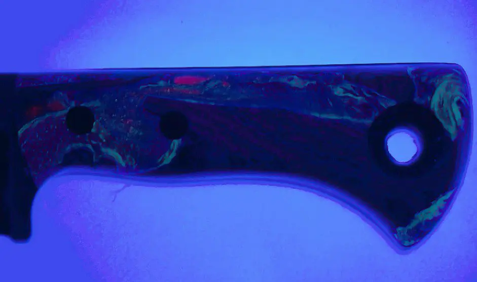 Fordite resin handle glowing under UV light, Fire Creek Forge Wharncliffe