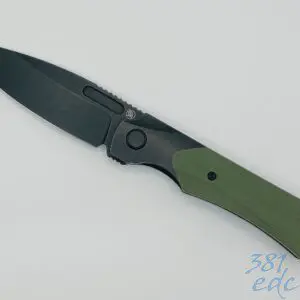 Griffin Co X Series open angled view showing black washed MagnaCut drop point blade and OD green G10 handle