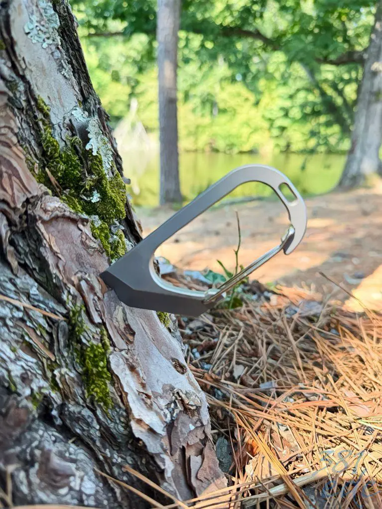 BeySeven Cutty Cutter Tool clipped to tree bark outdoors
