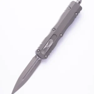 A sleek metallic folding knife with a pointed blade.