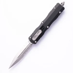 A sleek black automatic knife with a sharp pointed blade.