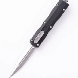 A sleek black automatic knife with a sharp silver blade extended.