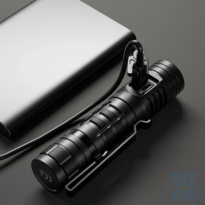 Wuben C2 flashlight connected to USB-C cable charging on desk